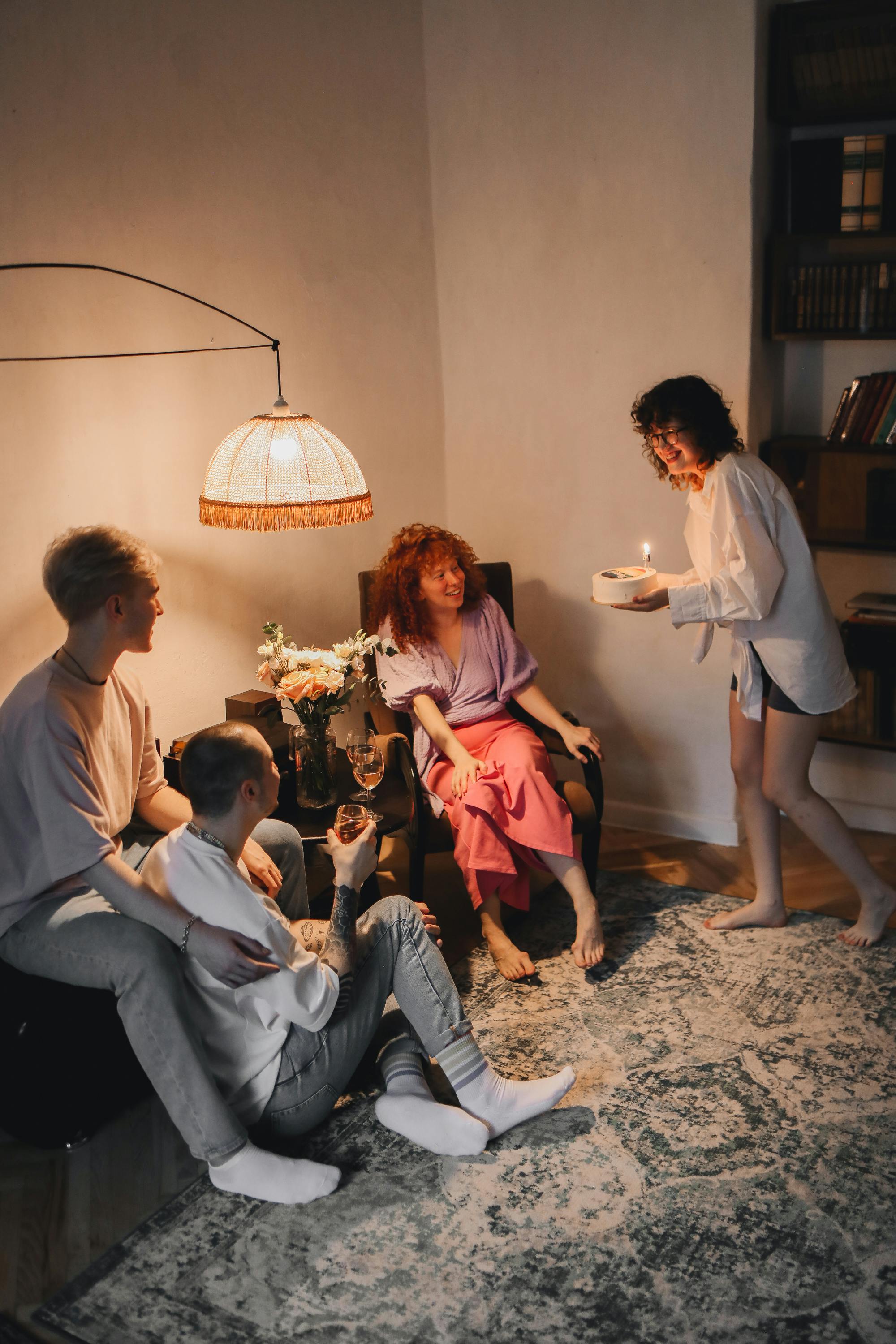 Small group seated in a living room during a relaxed house party.
