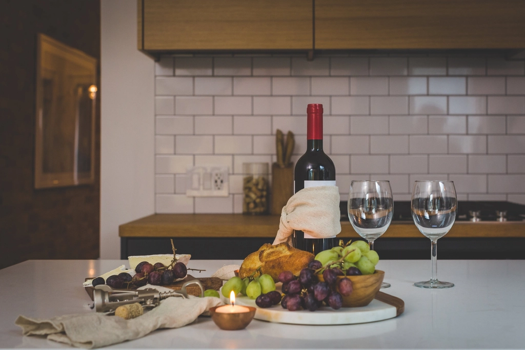 Drinks and appetizer station set on a kitchen counter for a house party.