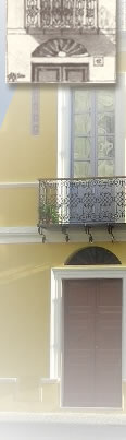 Historic yellow facade with wrought-iron balconies in Oristano