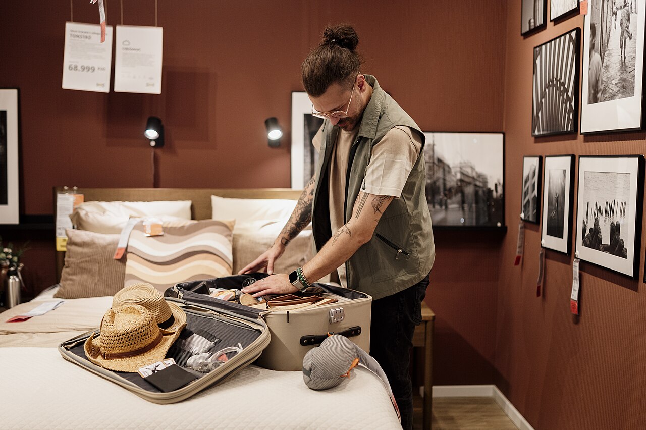 Packed suitcase and travel essentials in a bed and breakfast guest room.